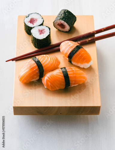 Fresh sushi platter with nigiri and maki rolls on wooden board photo