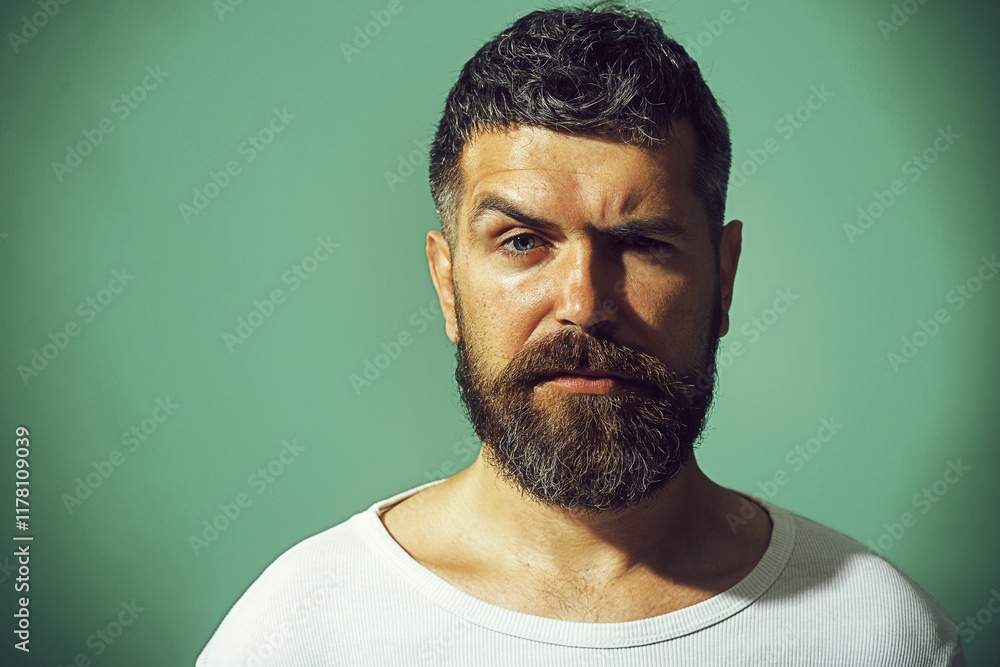 Man portrait. Handsome bearded man with stylish hairdo, closeup portrait. Serious pensive man with beard and mustache in casual clothes. Fashionable unshaven man in white sweater. Fashion male model. Man portrait. Handsome bearded man with stylish hairdo, closeup portrait. Serious pensive man with beard and mustache in casual clothes. Fashionable unshaven man in white sweater. Fashion male model.