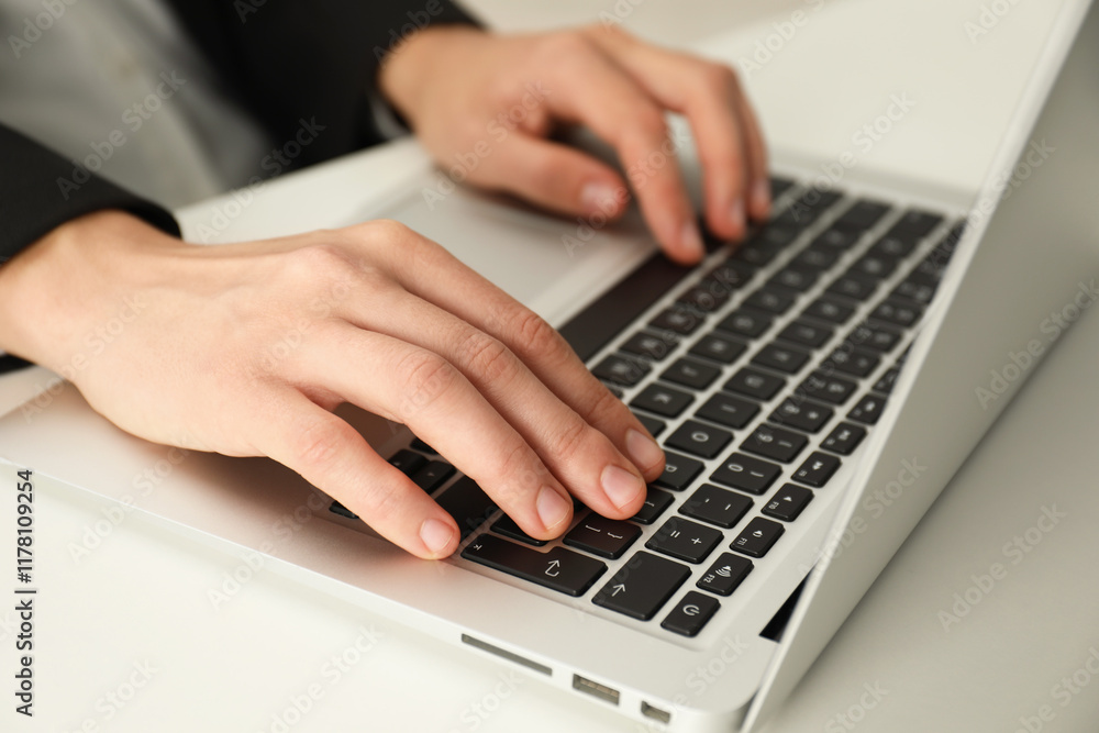 Businesswoman using laptop at white table indoors, closeup. Modern technology Businesswoman using laptop at white table indoors, closeup. Modern technology