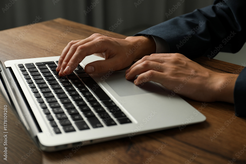 Businesswoman using laptop at wooden table indoors, closeup. Modern technology Businesswoman using laptop at wooden table indoors, closeup. Modern technology