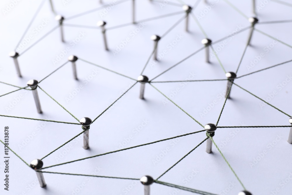 Network connection. Nails linked together by threads on white background, closeup Network connection. Nails linked together by threads on white background, closeup