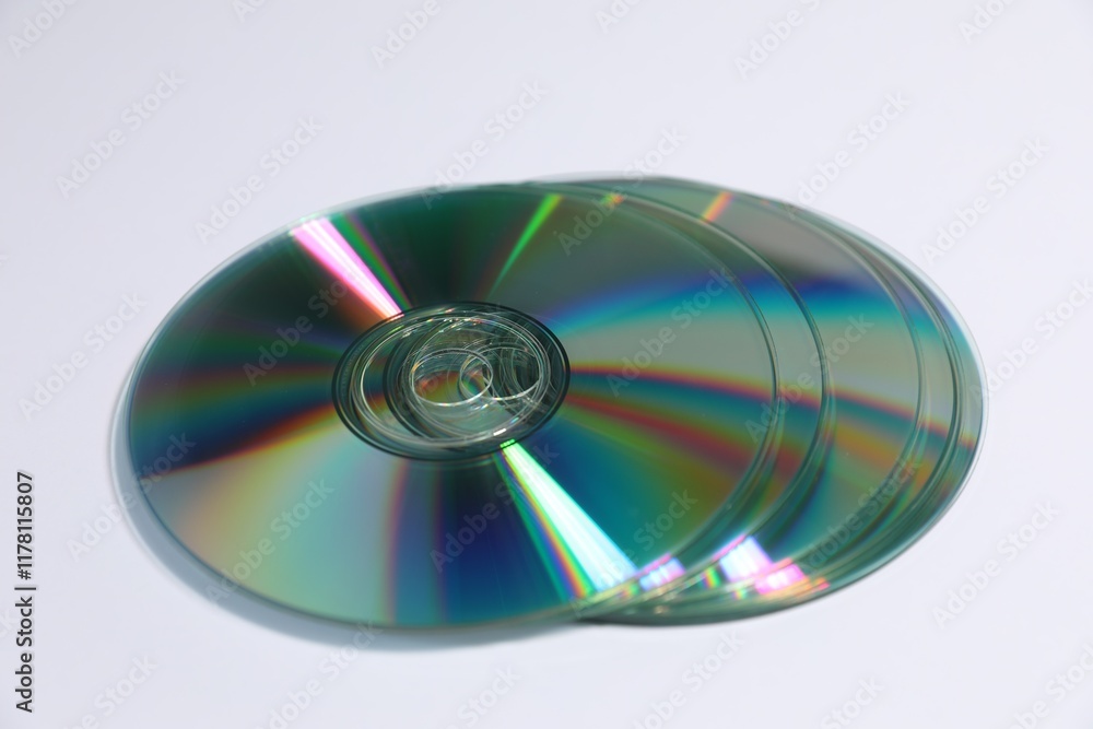Many shiny compact discs on light background Many shiny compact discs on light background