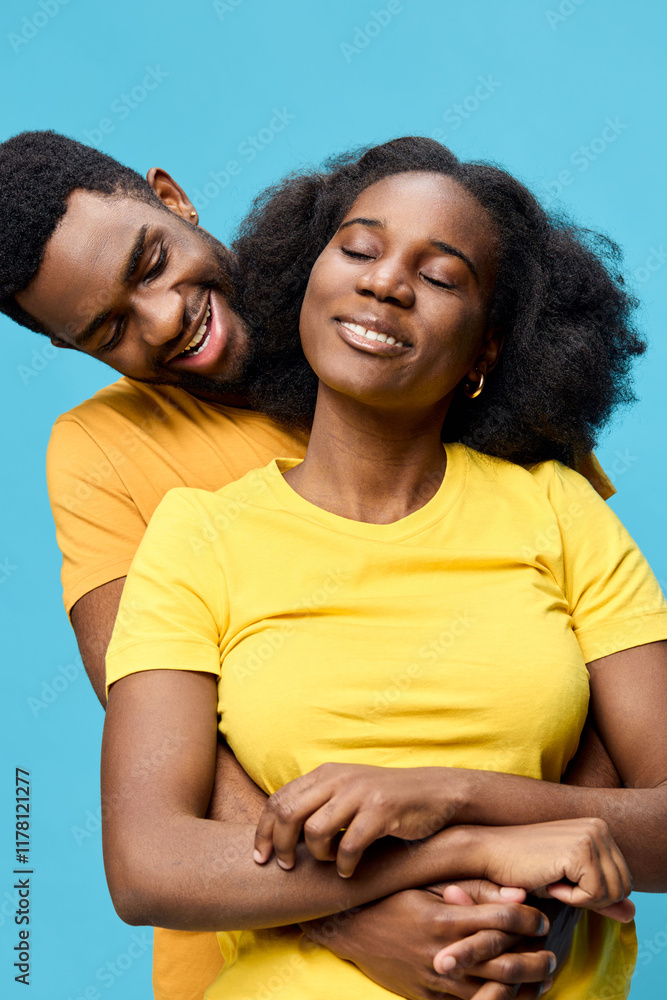 Joyful couple embracing with bright yellow shirts against a vibrant blue background, symbolizing love, happiness, and connection in a cheerful, warm atmosphere Joyful couple embracing with bright yellow shirts against a vibrant blue background, symbolizing love, happiness, and connection in a cheerful, warm atmosphere