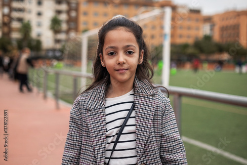 girl on a soccer field watching the game photo