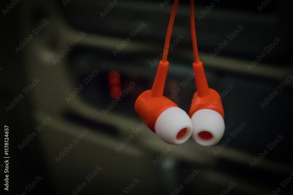 A pair of earbuds with red base and white part that goes into the ear. Airline specific ear plugs