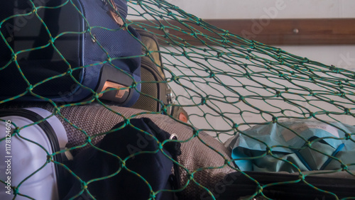Obraz na płótnie Suitcases, bags, packages under a big green cargo net in africa, senegal. Mean to fix the luggage.. w salonie