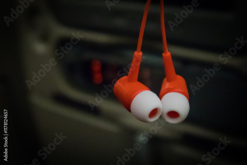 Obraz na płótnie A pair of earbuds with red base and white part that goes into the ear. Airline specific ear plugs w salonie