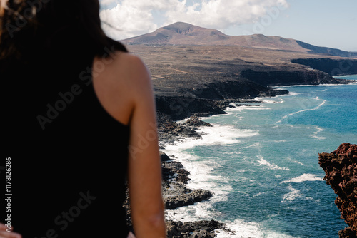 Fit unknown enthusiast gazing at volcanic seascapes of Canary Islands photo