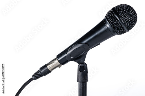 Obraz na płótnie Hand-held microphone on black table stand on white background connected to xlr cable. Concept: Radio, professional sound, brodcasting, podcast. w salonie