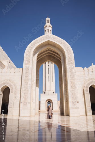 Tourist visiting the magnificent sultan qaboos grand mosque in Oman photo