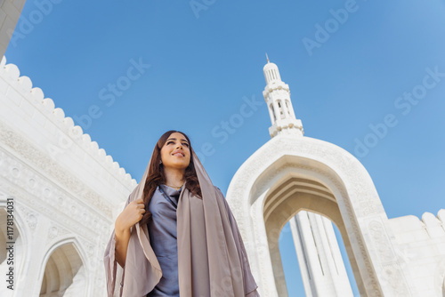 Omani woman visiting the majestic sultan qaboos grand mosque photo