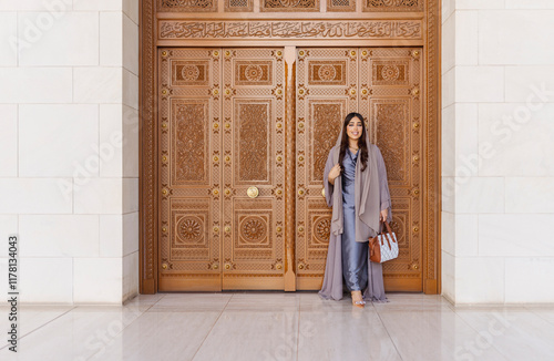 Tourist visiting the sultan qaboos grand mosque in muscat, oman photo