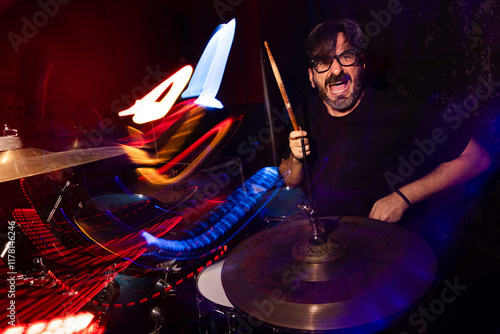 Energetic Drummer Performing with Vibrant Light Trails photo