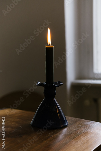 Burning Candle in Ceramic Holder photo