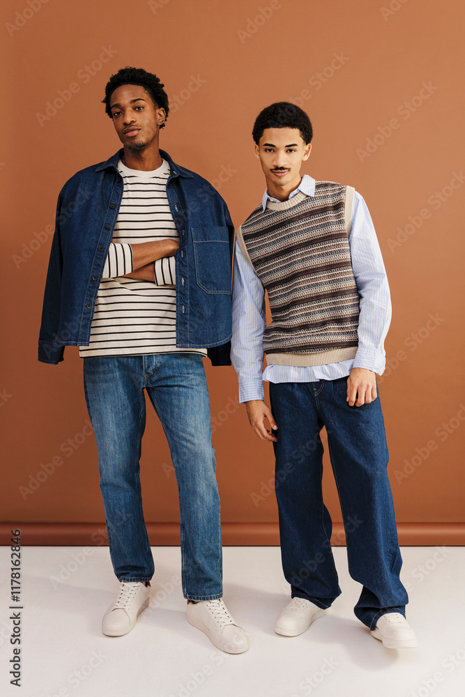 Two fashion models posing with casualwear in studio setting Two fashion models posing with casualwear in studio setting