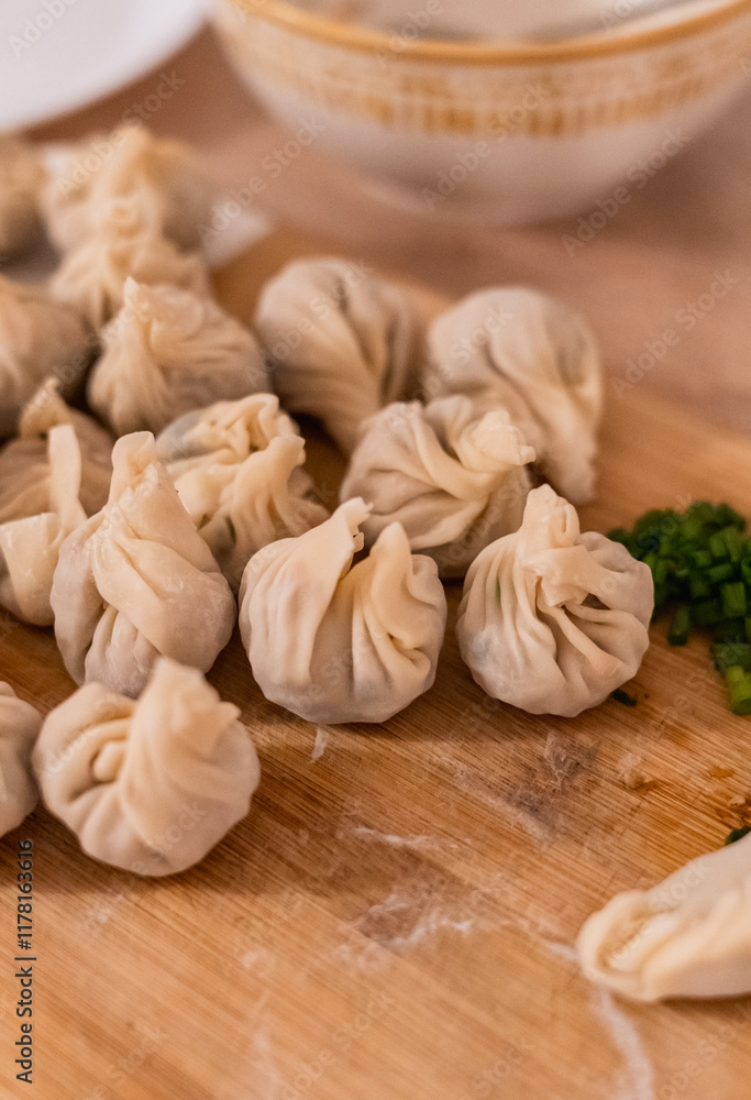 Close-up of freshly made homemade dumplings on a kitchen table Close-up of freshly made homemade dumplings on a kitchen table
