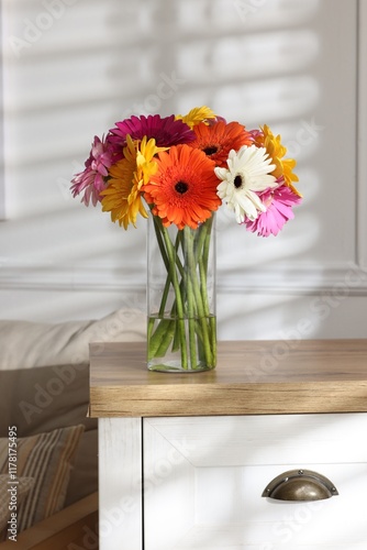 Wallpaper Mural Bouquet of beautiful gerbera flowers in glass vase on wooden chest of drawers indoors Torontodigital.ca