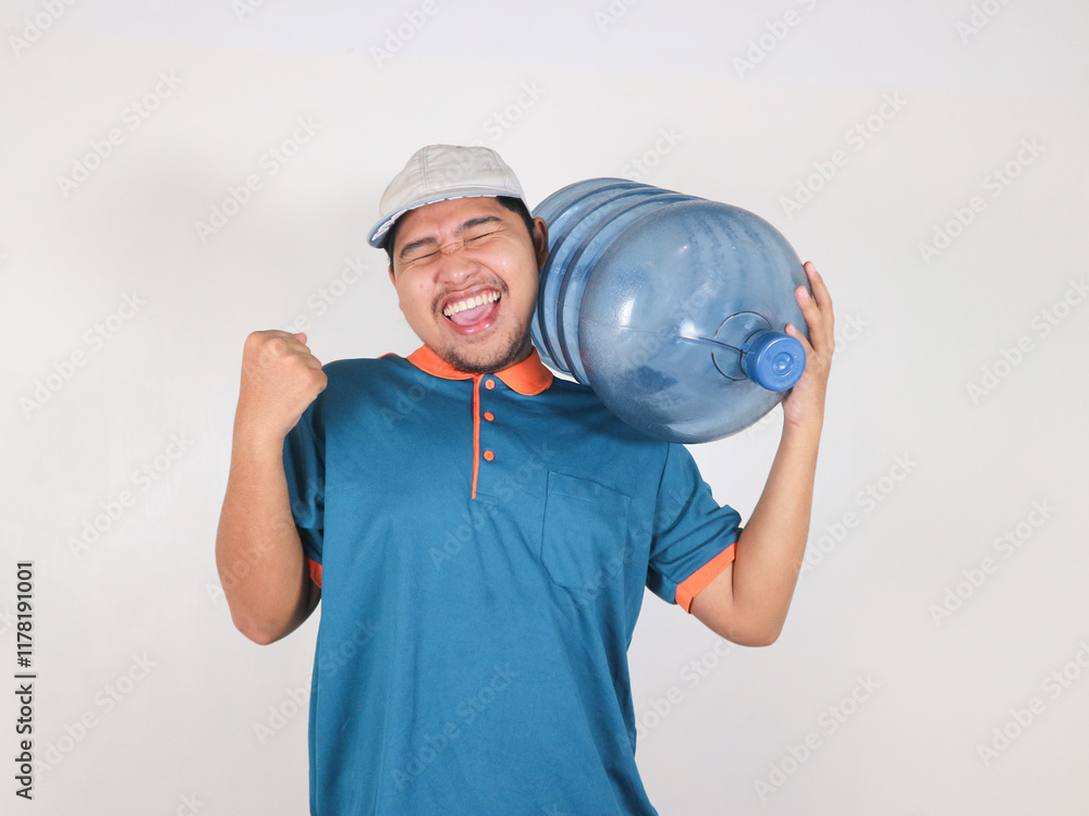 happy Asian delivery courier is carrying a gallon or big water bottle of mineral water doing winner gesture with arms raised, smiling and screaming for success. happy Asian delivery courier is carrying a gallon or big water bottle of mineral water doing winner gesture with arms raised, smiling and screaming for success.