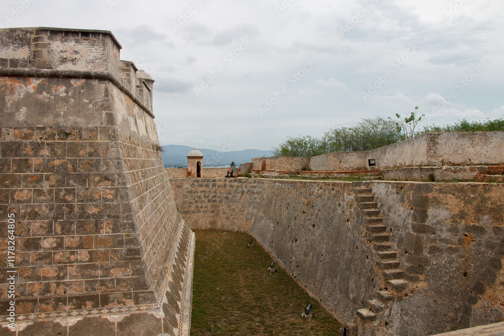 Fortified walls and a turret of Castillo del Morro or San Pedro de la Roca fortress XVII century fortress at the entrance of Santiago de Cuba bay. Fortified walls and a turret of Castillo del Morro or San Pedro de la Roca fortress XVII century fortress at the entrance of Santiago de Cuba bay.