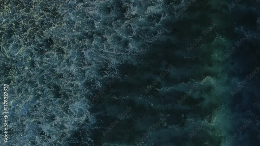Aerial top view of powerful dark ocean waves crashing with white foam. Captivating drone footage captures the dramatic sea tide on a stormy day, showcasing the raw beauty of the Caribbean Sea Aerial top view of powerful dark ocean waves crashing with white foam. Captivating drone footage captures the dramatic sea tide on a stormy day, showcasing the raw beauty of the Caribbean Sea