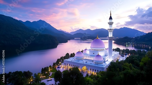 Majestic mosque by lake at sunset, mountains in background. photo