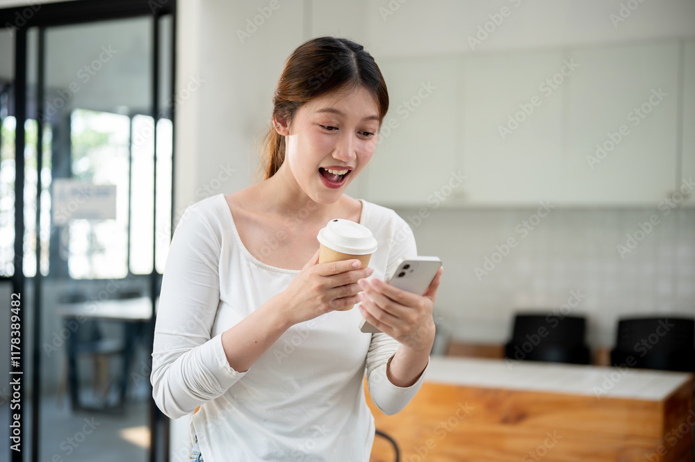 Excited woman reading texts on her smartphone with a surprised expression while standing in a cafe. Excited woman reading texts on her smartphone with a surprised expression while standing in a cafe.