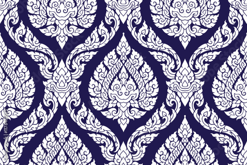 Traditional Thai art seamless white colored floral pattern in damask style motifs suitable for wallpaper, curtain, clothing, blanket, tile and fabric design isolated over blue background. 