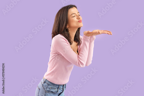 Young woman blowing kiss on...
