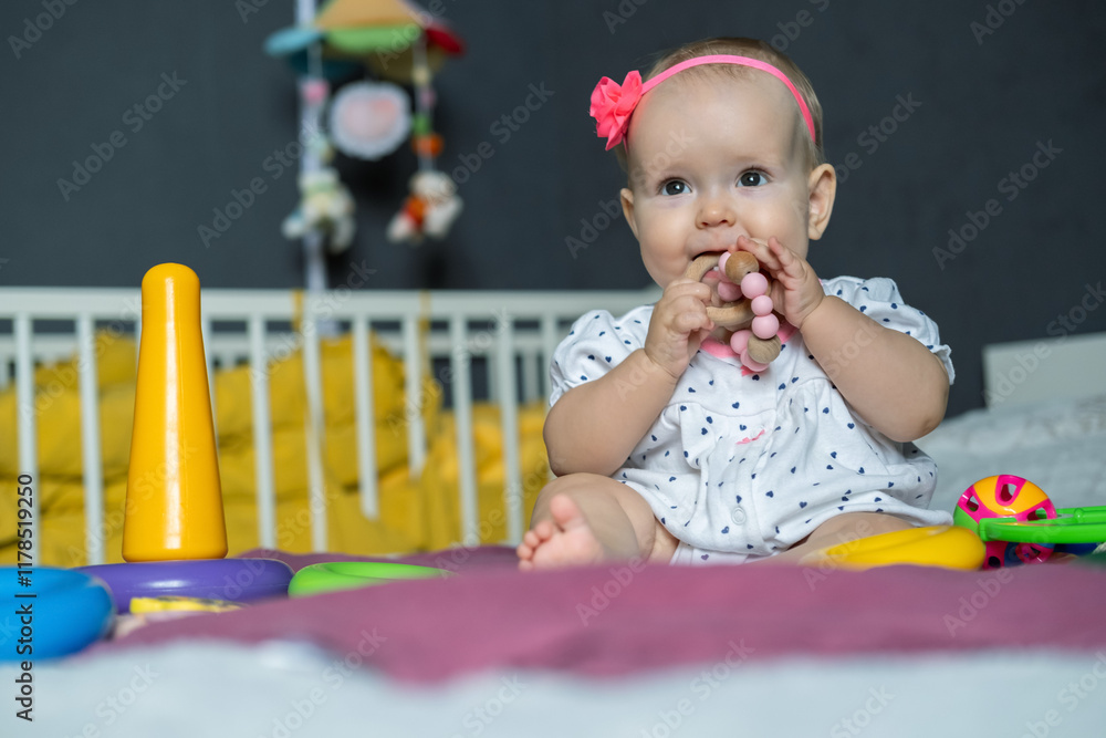 In a cozy indoor setting, a cheerful baby girl plays with colorful toys, smiling brightly while chewing on a teething ring. Soft pillows and a mobile create a warm atmosphere. In a cozy indoor setting, a cheerful baby girl plays with colorful toys, smiling brightly while chewing on a teething ring. Soft pillows and a mobile create a warm atmosphere.