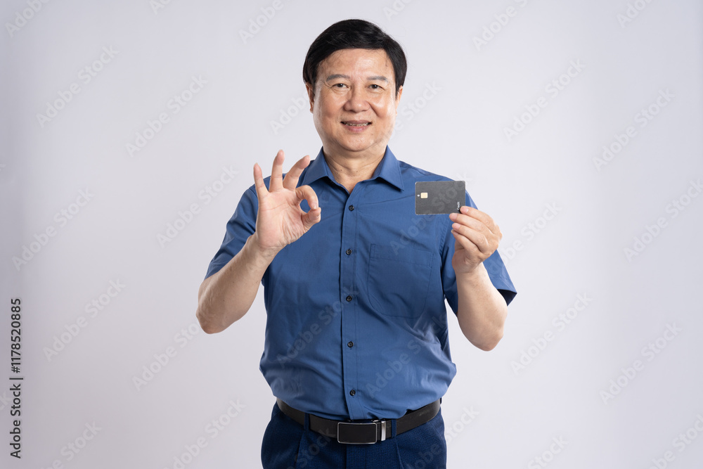 Fototapeta premium Portrait of elderly male businessman posing on white background