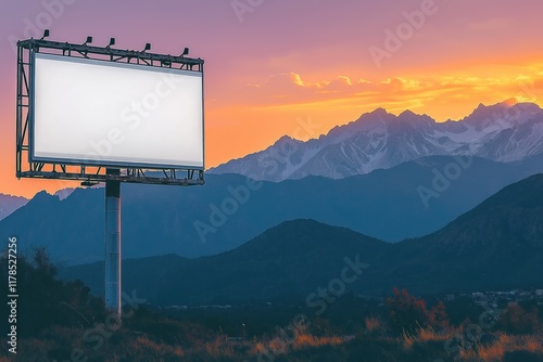 Billboard with dramatic mountain backdrop at sunset, silhouetted peaks, orange-purple sky, industrial metal frame, white surface, rugged terrain contrast. photo