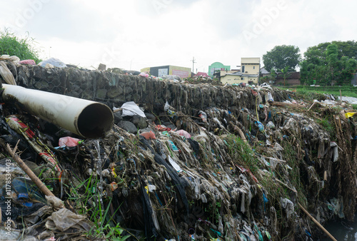 factory waste and household waste pollute the river