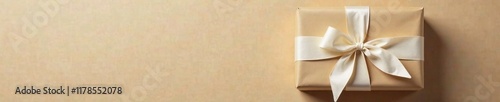 Wallpaper Mural Brown gift box wrapped in beige paper with white bow tied around it, beige, rustic, present Torontodigital.ca