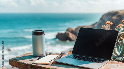 Laptop with blank screen and coffee cup on the beach. Work from home concept.