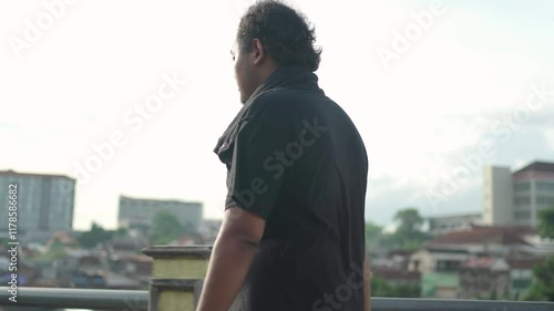 asian fat man drink water then walking for exercise