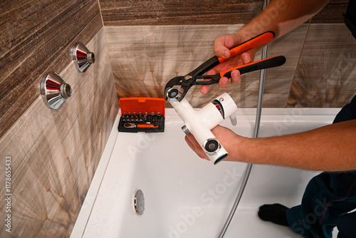 Wallpaper Mural Professional plumber working carefully, installing or repairing bathtub faucet in modern bathroom Torontodigital.ca