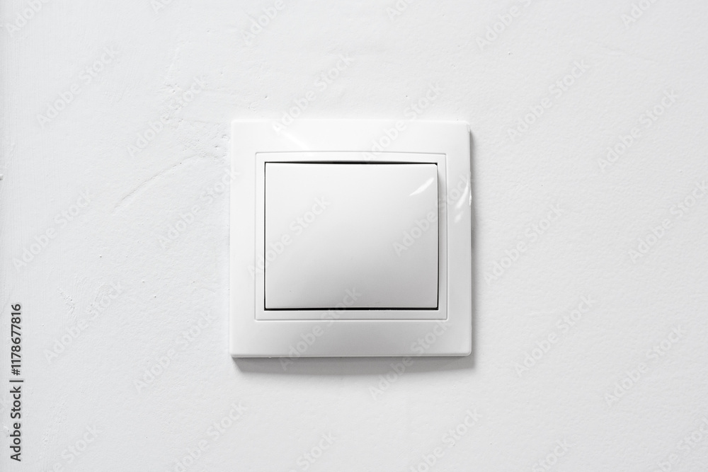 White light switch on a plain wall, designed for easy access and modern aesthetics in home interiors White light switch on a plain wall, designed for easy access and modern aesthetics in home interiors