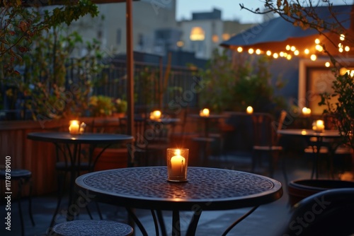 A serene rooftop setting featuring candlelit tables amidst greenery. Soft ambient light creates a cozy atmosphere, perfect for relaxation and social gatherings. photo