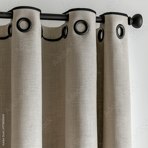 A photograph of linen and cotton striped curtains with black trim, against a white background. The curtains have eyelets at the top and bottom, and are shown in a three-quarter vie photo