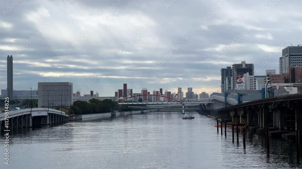 A serene view of Tokyo cityscape with a river, bridges, and cloudy sky A serene view of Tokyo cityscape with a river, bridges, and cloudy sky