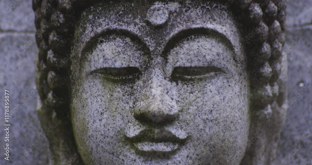 A religious stone statue of Akshobhya at Japanese buddhism temple A religious stone statue of Akshobhya at Japanese buddhism temple