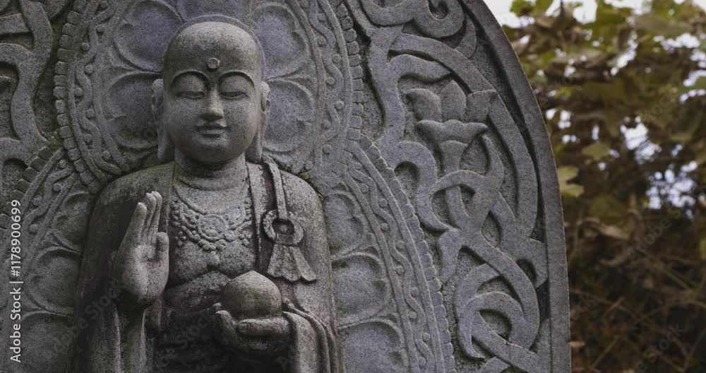 A religious stone statue of Jizo at Japanese buddhism temple A religious stone statue of Jizo at Japanese buddhism temple