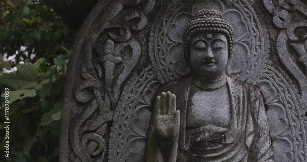 A religious stone statue of Medicine Buddha at Japanese buddhism temple A religious stone statue of Medicine Buddha at Japanese buddhism temple