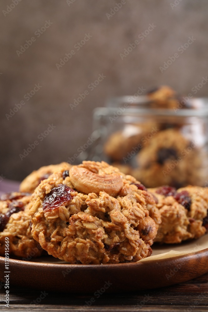 Delicious oatmeal cookies with raisins and nuts on wooden table, closeup Delicious oatmeal cookies with raisins and nuts on wooden table, closeup