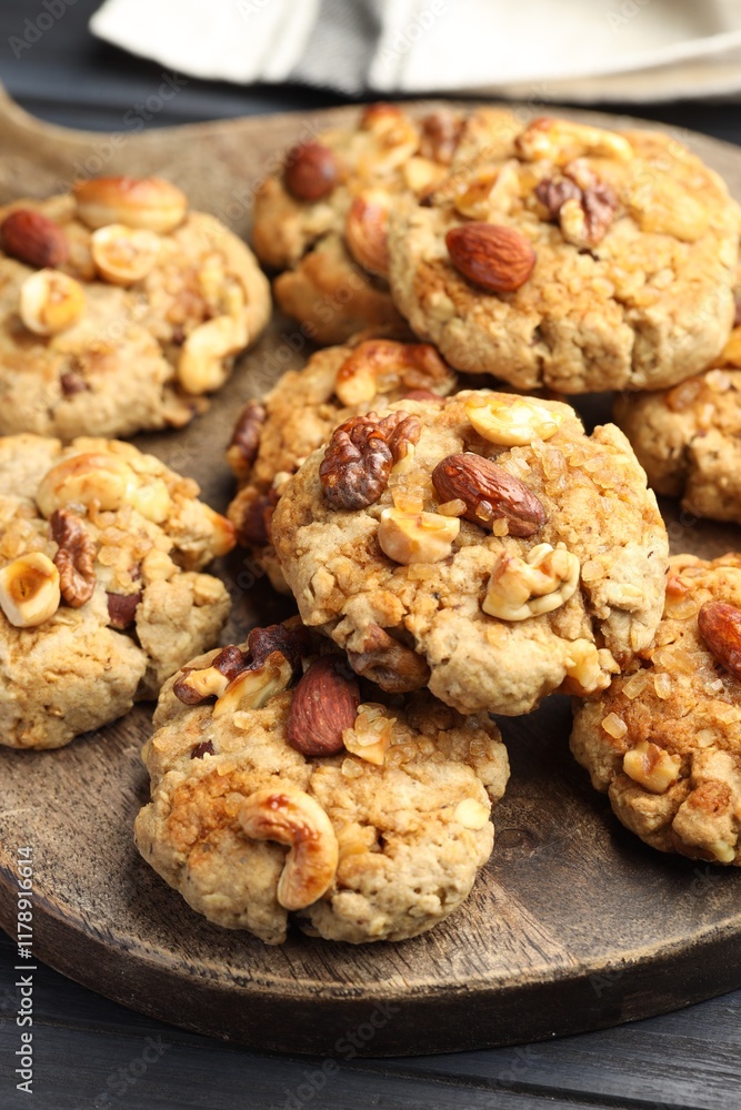 Tasty cookies with nuts on dark wooden table, closeup Tasty cookies with nuts on dark wooden table, closeup