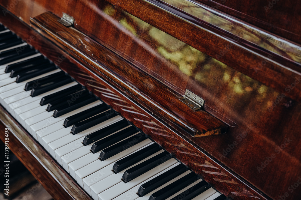 Beautiful wooden piano keys captured in warm sunlight, highlighting intricate details and rich texture