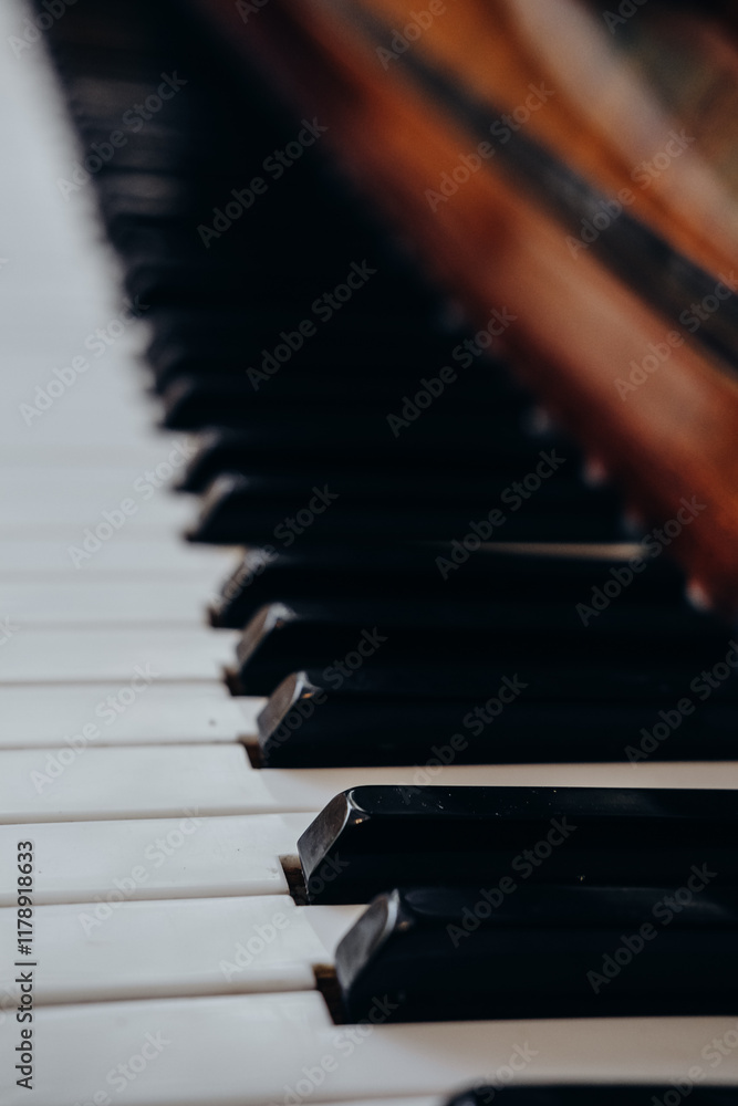 Close-up view of piano keys with wood accents showcasing musical texture and artistry indoors Close-up view of piano keys with wood accents showcasing musical texture and artistry indoors