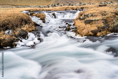 Panoramic view of flowing rushing water on the river in Kirkjubæjarklaustur or Kirkjubaejarklaustur, Iceland. Nature, travel, winter background, or wallpaper photo