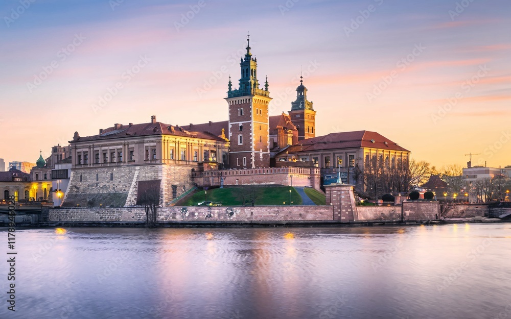 Fototapeta premium Krakow's Wawel Castle, Poland Majestic castle at sunset, reflected in calm river water.