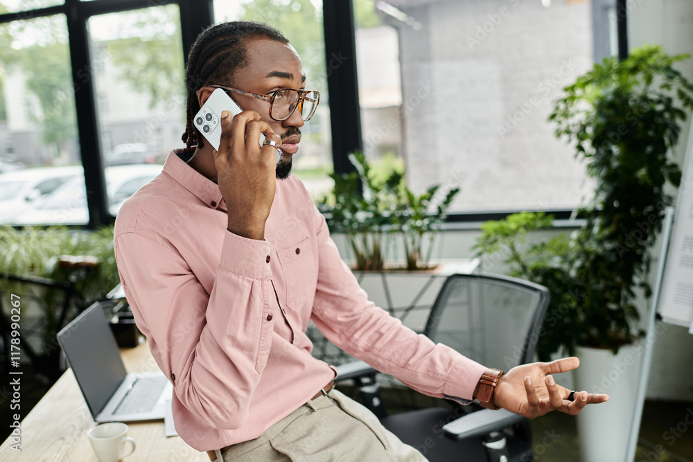 Dynamic young man engaging in remote work while enjoying a vibrant office environment Dynamic young man engaging in remote work while enjoying a vibrant office environment
